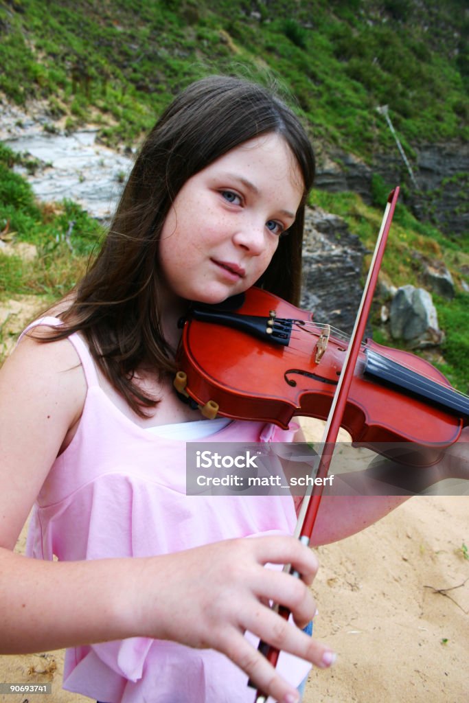 Violin Series A girl with pale skin playing a Violin at the beach  Aperture Stock Photo