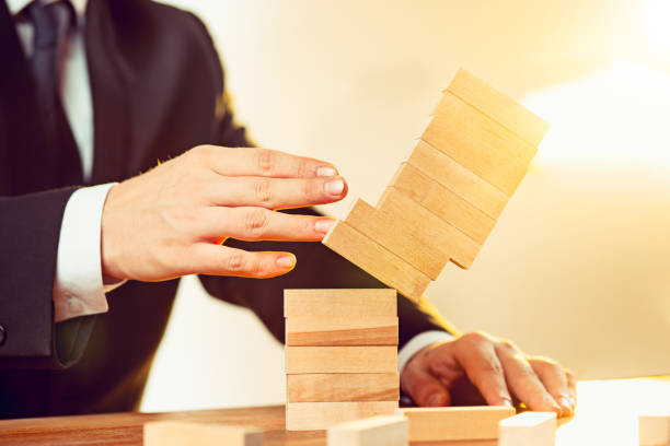 istock Man and wooden cubes on table. Management concept 906951158