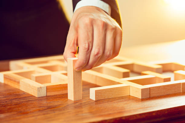 istock Man and wooden cubes on table. Management concept 906953478