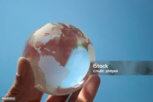 Hand Holding Globe Model On Blue Background Stock Photo - Download Image Now - Market - Retail Space, Global, Global Communications