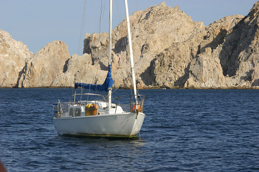 Yacht anchored near cliffs in Cabo San Lucas Mexico