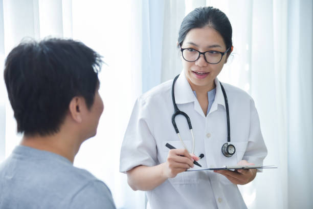 istock Female Doctor examining male patients. 906962842