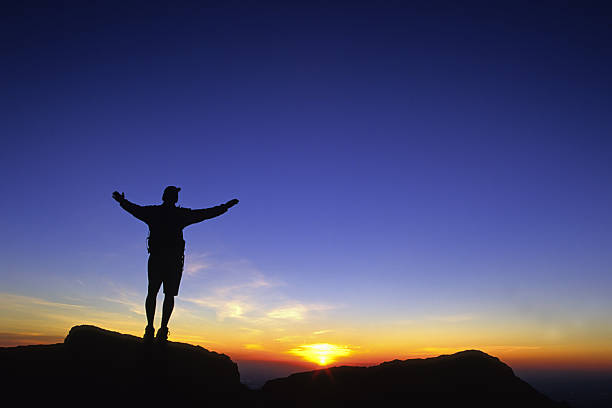 istock celebrating the sunrise sky (man silhouette with arms spread wide)! 90696624