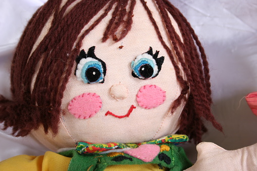 Homemade rag doll named Hansel.  Hansel has been around for about 30 years and has had a smile on his face all of that time.  He has lost some hair but that doesn't hurt his good looks.