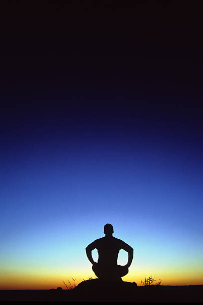 istock sitting yoga silhouette abstract twilight sky 90697284