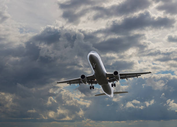 istock Airplane flying in sky with clouds at sunset time 906981206