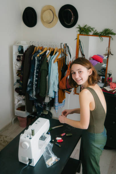 istock Woman sewing in her studio room 906985214