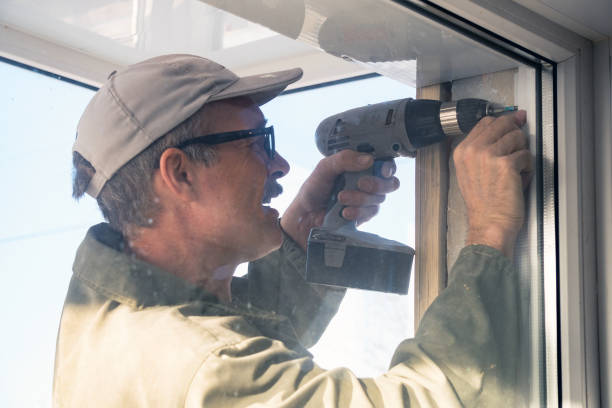 istock Carpenter in glasses with a drill 906992260