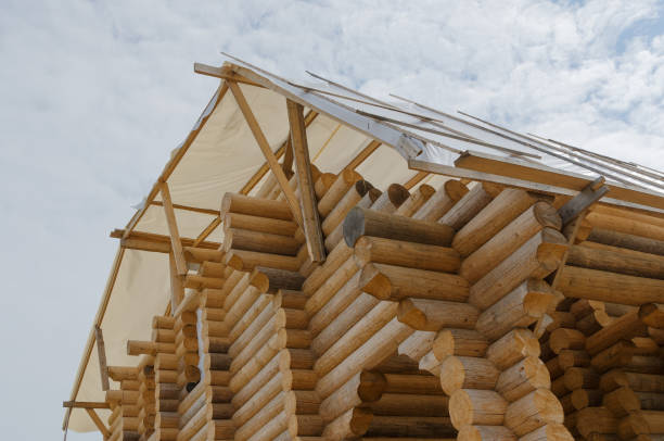 istock log Structure of new wooden house under construction 906993366