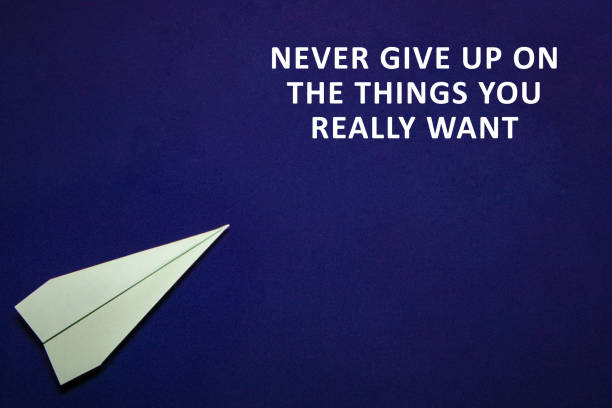 istock colored paper plane on a dark blue background. Teamwork concept. Never give up on the things you really want 906993716