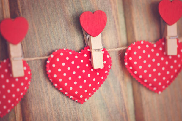 istock Red hearts hanging on wooden background. 906993872