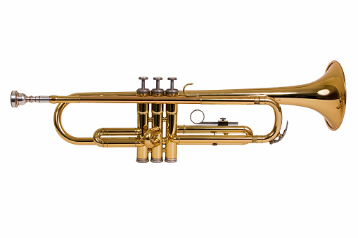 Gold colored trumpet as an isolated musical instrument against a white background in a studio