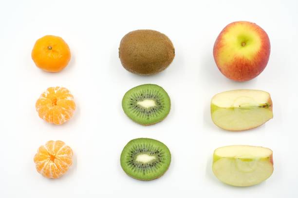 istock orange, kiwifruit and apple knolling on white background 907002902