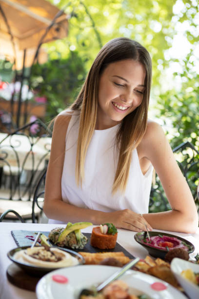 istock Woman in outdoor restaurant 907013202