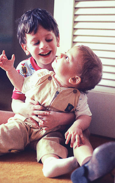 istock Big brother hugging her baby sister 907020174