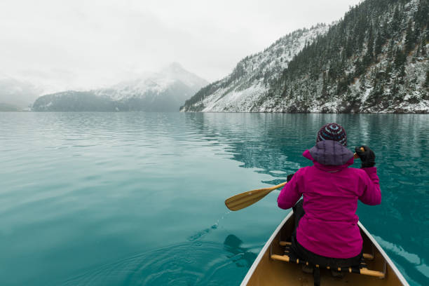 istock Female adventurer canoeing an alpine lake 907021324