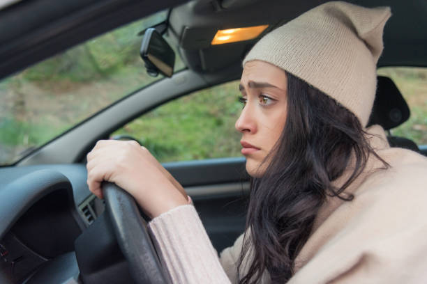 Scared woman driver in car. Inexperienced anxious motorist