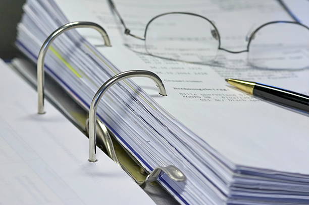 istock An open binder with a pair of glasses and a pen 90704360