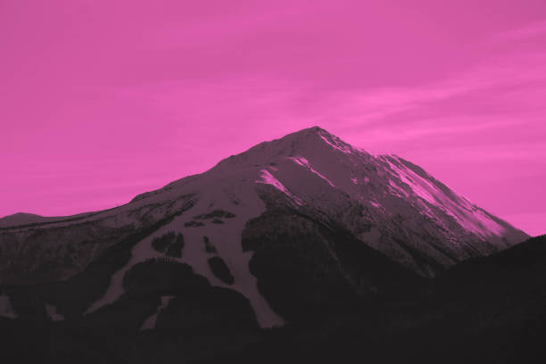 istock Beautiful sunset view on the high winter mountains peaks, on the sky background. 907045134