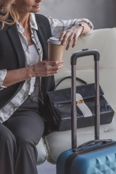 istock woman with suitcase and coffee 907058562