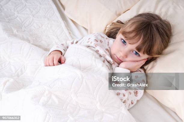 Child In Bed With Hand On Cheek Stock Photo - Download Image Now - Child, Toothache, Sleeping
