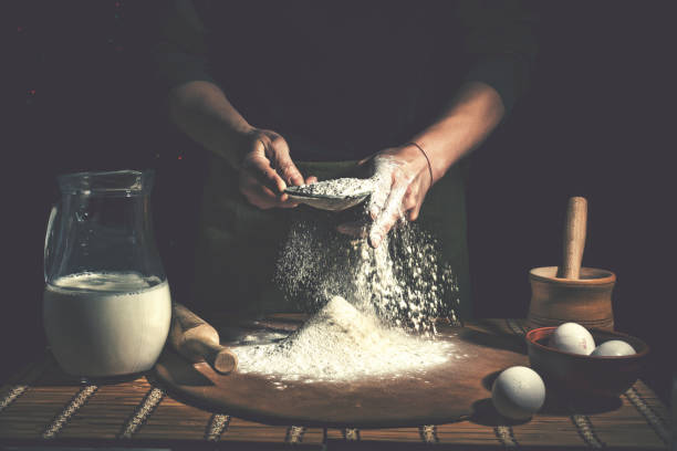 man preparing bread dough on wooden table in a bakery close up. preparation of easter bread. - chef baker bakery flour imagens e fotografias de stock