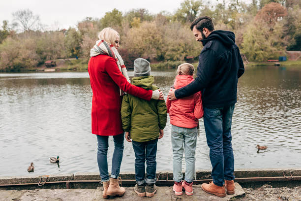 istock family near lake in park 907085250