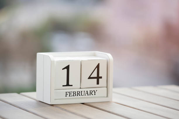 istock Cube shape calendar for February 14 on wooden surface. 907086154