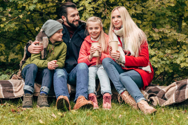 istock family with paper cups in park 907095338