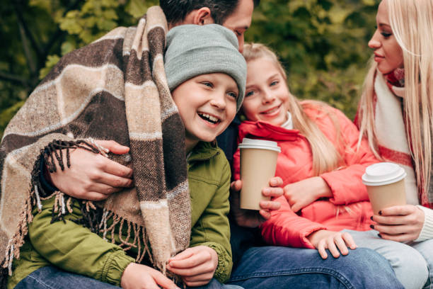 istock family with paper cups in park 907095632
