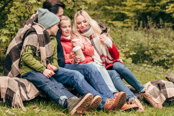 istock family with paper cups in park 907096418