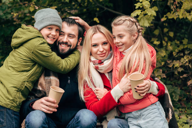 istock family with paper cups in park 907097184