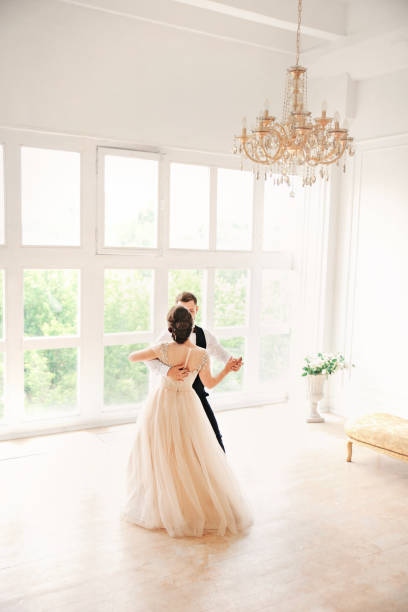 wedding couple dances first dance on the studio. Wedding day. Happy young bride and groom on their wedding day. Wedding couple - new family. stock photo