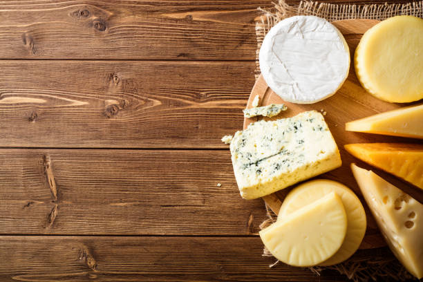 istock Various types of cheese on dark rustic wooden background. 907109648