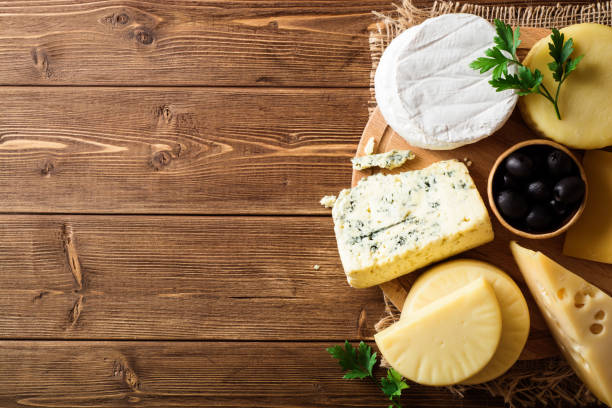 istock Various types of cheese on dark rustic wooden background. 907114088