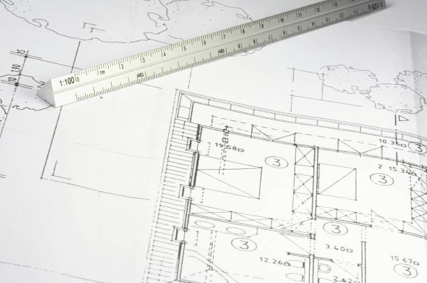 Precision pen and transparent ruler on an architects plan