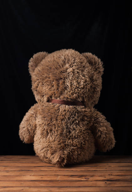 istock A lone Teddy bear sits on a wooden surface, 907150192
