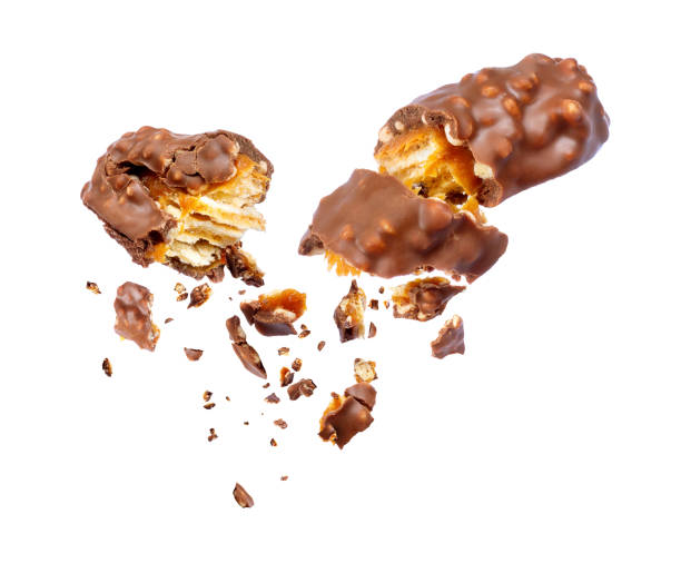 istock Waffle chocolate bar with nuts broken into two parts on white background 907161822