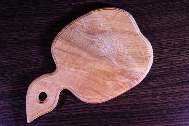 istock Cutting board on the dark wooden table. Top view 907174386