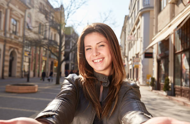 istock young girl make a selfy on the street in spring 907174662
