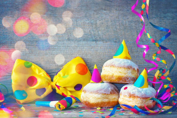 carnival donuts with paper streamers and party bow tie - renânia imagens e fotografias de stock