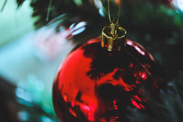 istock Christmas tree decoration background, sparkling red ball on a fir tree closeup. 907190064