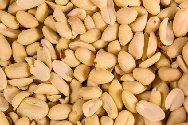 istock Texture of peeled roasted peanuts for the background 907191484