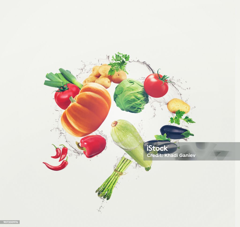 Flying organic food with water splash. Food illustration different vegetables and water splash on isolated white background food, vegetables, organic, background, isolated Flying Stock Photo