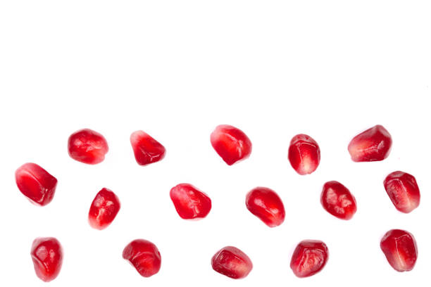 istock pomegranate seeds isolated on white background with copy space for your text. Top view. Flat lay pattern 907203054