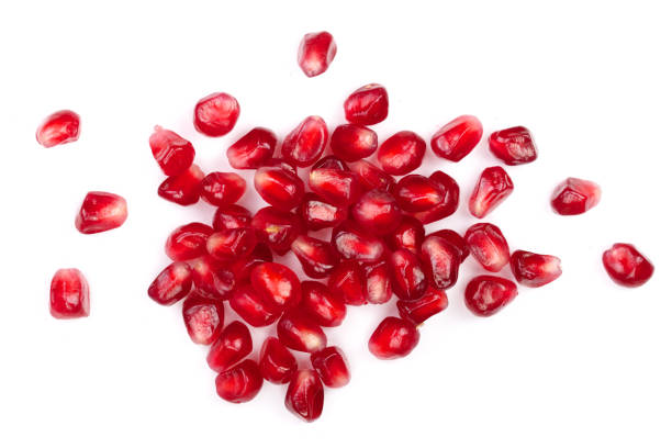 istock pomegranate seeds isolated on white background. Top view. Flat lay pattern 907203290