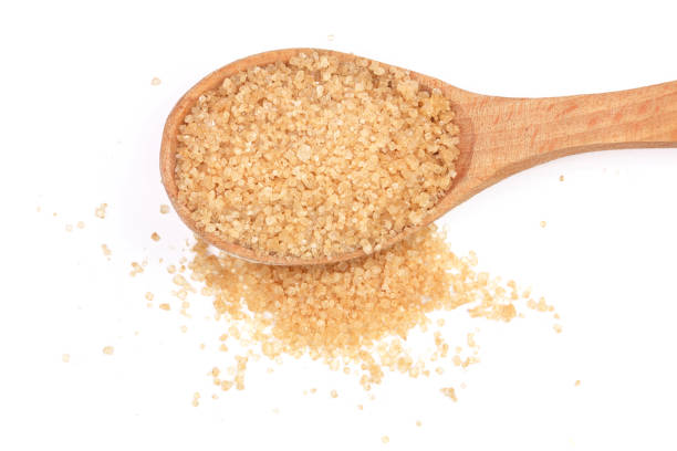 istock brown sugar in wooden spoon isolated on white background. Top view. Flat lay 907206356