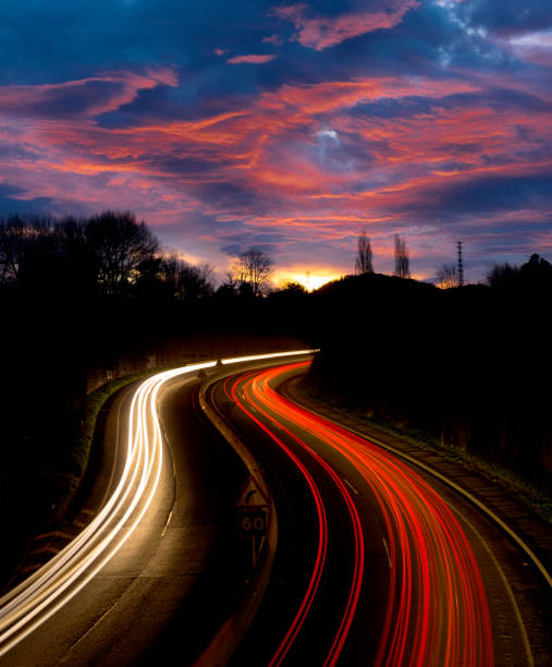 istock Car lights at sunset on the road. 907208956