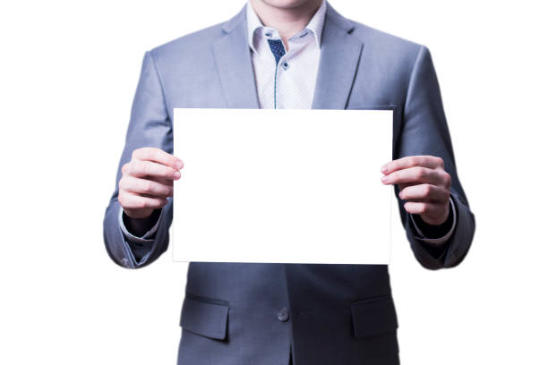 istock Businessman in grey suit holding blank paper on white background. 907228510