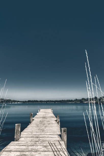 istock Wooden pier with blue sea and sky background 907232982